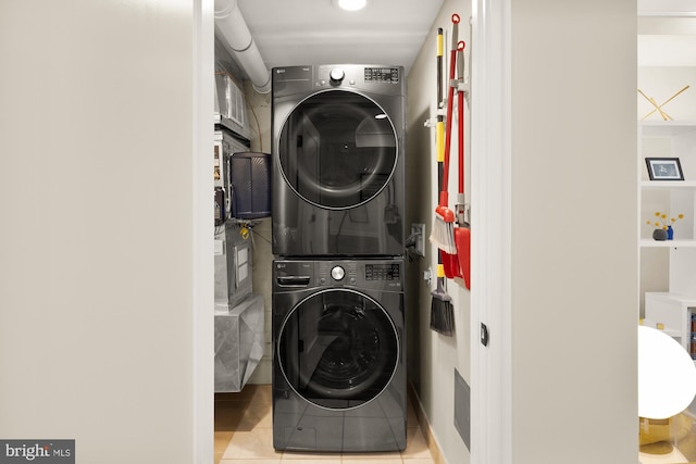 1217 Carrollsburg Pl SW, Washington, DC 20024 - washroom featuring stacked washer and clothes dryer and tile patterned flooring