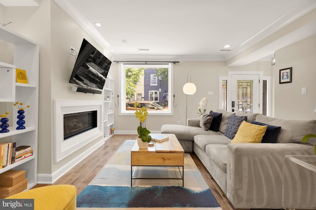 1217 Carrollsburg Pl SW, Washington, DC 20024 - living area featuring light wood-type flooring, a glass covered fireplace, recessed lighting, and baseboards