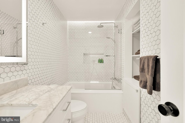 1217 Carrollsburg Pl SW, Washington, DC 20024 - full bath featuring vanity, bathtub / shower combination, tile patterned floors, toilet, and tile walls