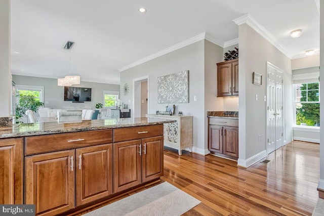 3300 Shore Dr, Annapolis, MD 21403 - kitchen featuring light wood finished floors, healthy amount of natural light, brown cabinetry, crown molding, and recessed lighting