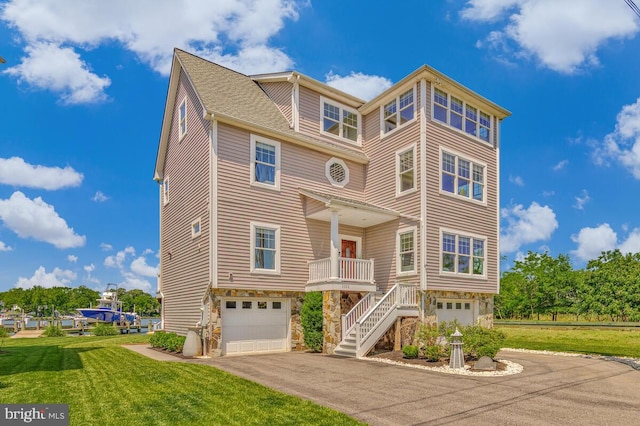 3300 Shore Dr, Annapolis, MD 21403 - coastal home featuring a garage, asphalt driveway, stone siding, and a front yard