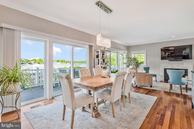3300 Shore Dr, Annapolis, MD 21403 - dining room featuring crown molding, a premium fireplace, and wood finished floors