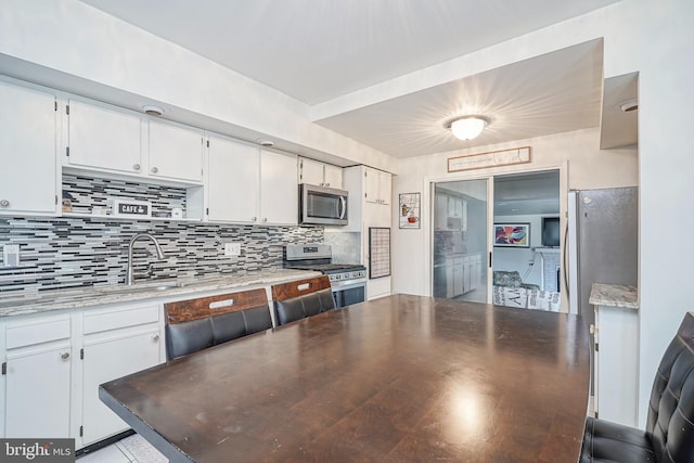 3725 King Ave, Pennsauken, NJ 08110 - kitchen featuring appliances with stainless steel finishes, tasteful backsplash, white cabinetry, and light countertops