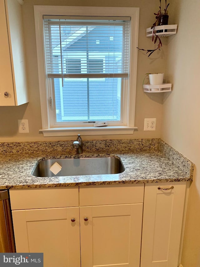 3528 14th St N, Arlington, VA 22201 - kitchen with a sink, white cabinets, and light stone counters