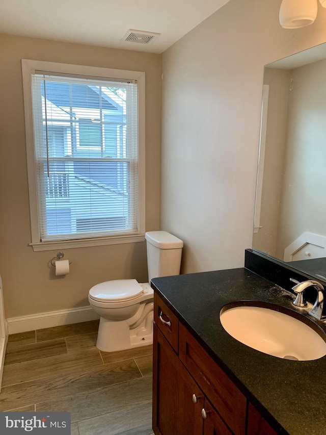 3528 14th St N, Arlington, VA 22201 - bathroom featuring toilet, healthy amount of natural light, vanity, and baseboards