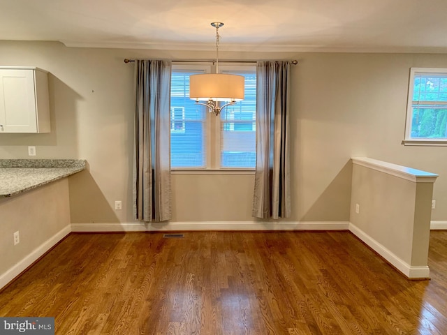3528 14th St N, Arlington, VA 22201 - unfurnished dining area featuring dark wood-style floors, plenty of natural light, baseboards, and crown molding