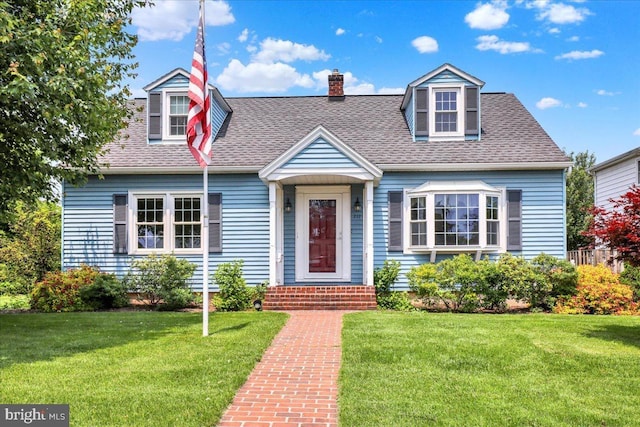 217 E Chestnut St, Cleona, PA 17042 - new england style home with a front yard, a chimney, and a shingled roof