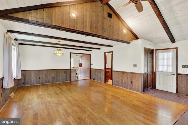 217 E Chestnut St, Cleona, PA 17042 - unfurnished living room with a wainscoted wall, wood walls, a ceiling fan, and wood finished floors