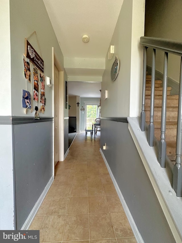 127 Miles Cir, Hurlock, MD 21643 - hallway with light tile patterned flooring, stairway, and baseboards