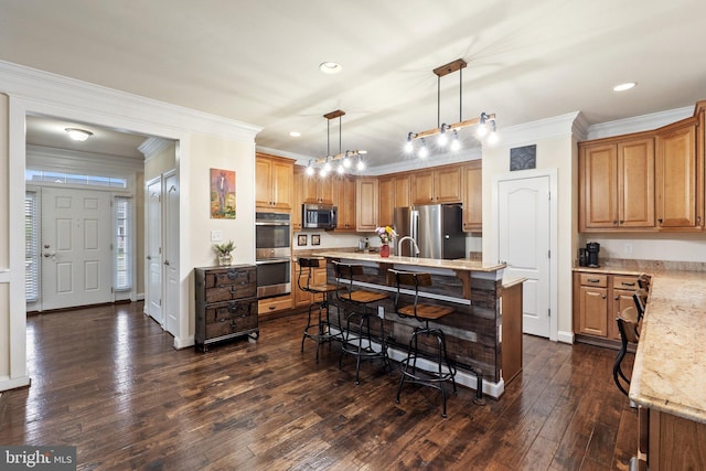 1257 N Fairfax Blvd, Ranson, WV 25438 - kitchen featuring appliances with stainless steel finishes, a breakfast bar, ornamental molding, an island with sink, and dark wood-style floors