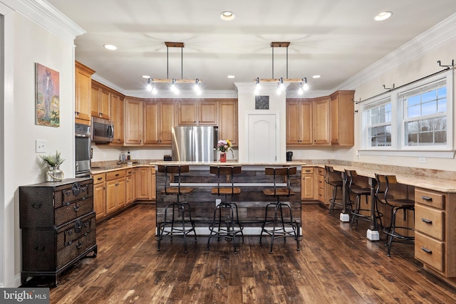 1257 N Fairfax Blvd, Ranson, WV 25438 - kitchen with appliances with stainless steel finishes, a breakfast bar area, ornamental molding, dark wood-style floors, and a center island
