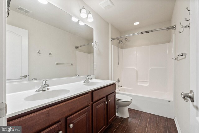 1257 N Fairfax Blvd, Ranson, WV 25438 - bathroom with toilet, wood finished floors, double vanity, and shower / tub combination