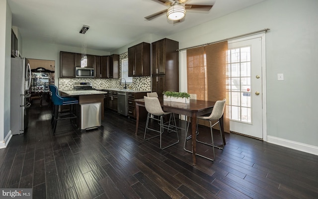 8 Bordeaux Blvd, Newark, DE 19702 - kitchen featuring stainless steel appliances, dark brown cabinets, ceiling fan, light countertops, and plenty of natural light