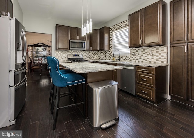 8 Bordeaux Blvd, Newark, DE 19702 - kitchen with stainless steel appliances, dark brown cabinets, a center island, and dark wood-type flooring