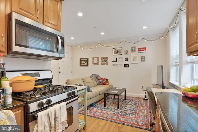 1443 Oak St NW Unit 102, Washington, DC 20010 - living area featuring wood finished floors, baseboards, and recessed lighting