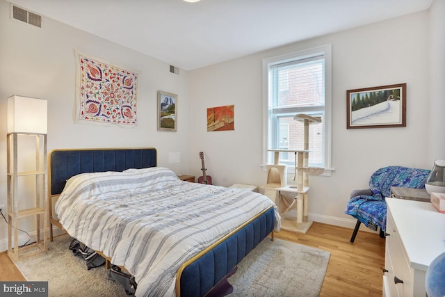 1443 Oak St NW Unit 102, Washington, DC 20010 - bedroom with light wood finished floors and baseboards