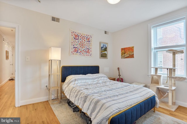 1443 Oak St NW Unit 102, Washington, DC 20010 - bedroom featuring light wood-type flooring and baseboards