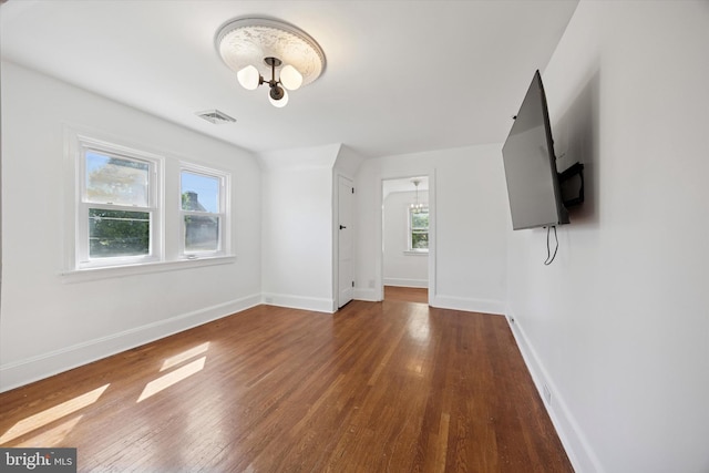 722 Mason Ave, Drexel Hill, PA 19026 - unfurnished living room with a chandelier, wood-type flooring, and baseboards
