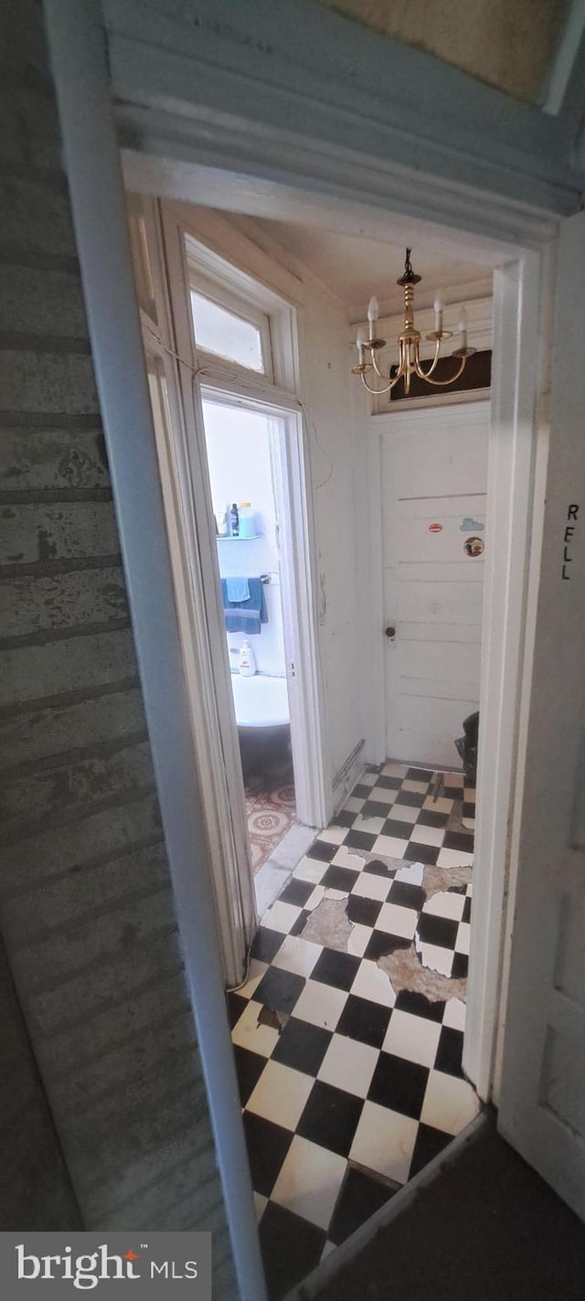 2207 W Lafayette Ave, Baltimore, MD 21216 - hallway featuring light floors and a chandelier