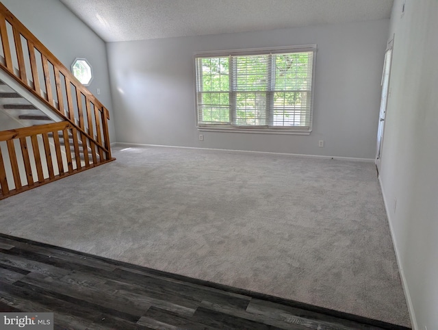 312 Mitten Ln, Mount Laurel, NJ 08054 - unfurnished living room with baseboards, carpet flooring, a textured ceiling, and stairs