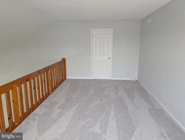 312 Mitten Ln, Mount Laurel, NJ 08054 - additional living space featuring a textured ceiling, carpet flooring, vaulted ceiling, and baseboards