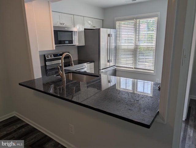 312 Mitten Ln, Mount Laurel, NJ 08054 - kitchen with appliances with stainless steel finishes, a sink, dark stone counters, and dark wood-style floors
