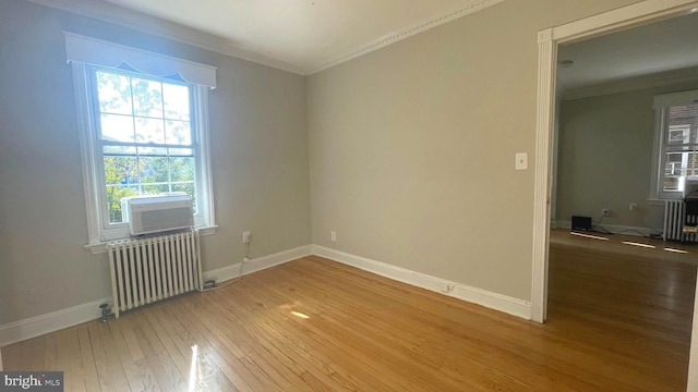 721 Erie Ave Unit 721-2, Takoma Park, MD 20912 - empty room featuring radiator heating unit, light wood-style floors, crown molding, and baseboards