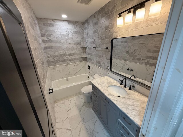 422 11th St SE, Washington, DC 20003 - bathroom with marble look tiles, vanity, toilet, washtub / shower combination, and recessed lighting