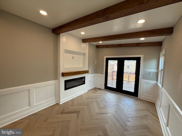 422 11th St SE, Washington, DC 20003 - unfurnished living room with a decorative wall, french doors, recessed lighting, beam ceiling, and a fireplace