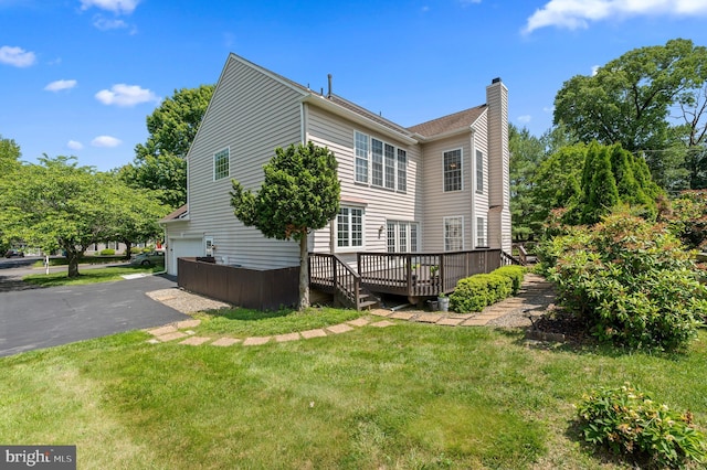 859 Empress Rd, West Chester, PA 19382 - view of property exterior with a chimney, a garage, a deck, a yard, and driveway