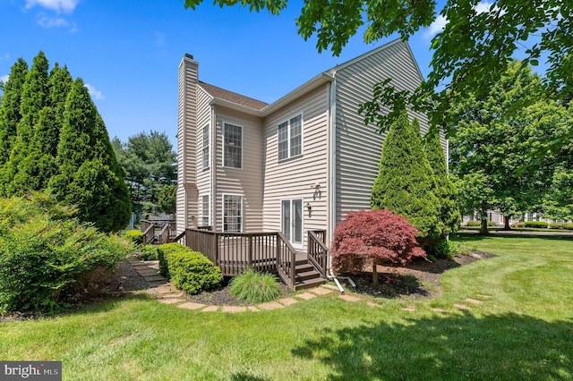 859 Empress Rd, West Chester, PA 19382 - view of side of property with a chimney, a wooden deck, and a lawn
