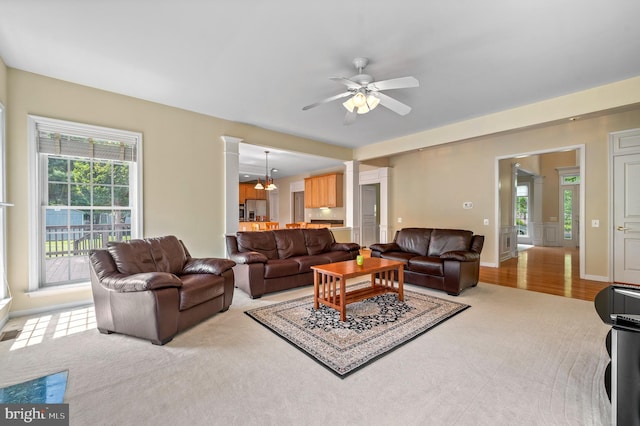 859 Empress Rd, West Chester, PA 19382 - living area with ornate columns, ceiling fan, light colored carpet, and baseboards