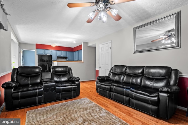 10462 Brackets Ford Cir, Manassas, VA 20110 - living room featuring ceiling fan, light wood-style floors, a textured ceiling, and baseboards
