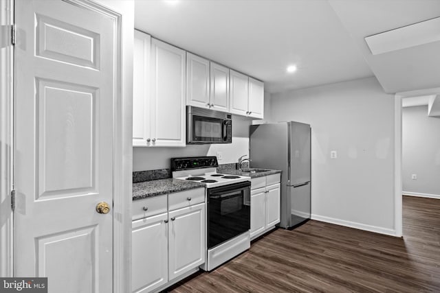 10462 Brackets Ford Cir, Manassas, VA 20110 - kitchen with range with electric stovetop, freestanding refrigerator, dark wood-style floors, white cabinets, and recessed lighting