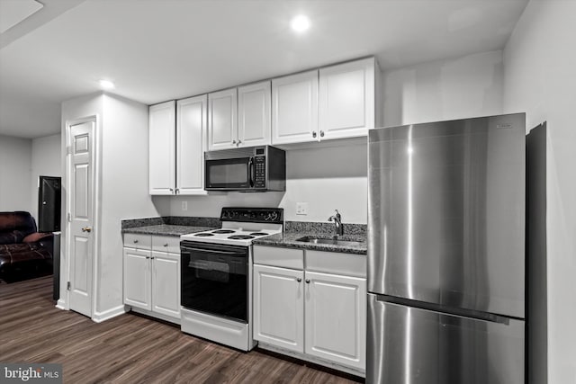 10462 Brackets Ford Cir, Manassas, VA 20110 - kitchen with freestanding refrigerator, electric stove, black microwave, a sink, and dark wood-style flooring