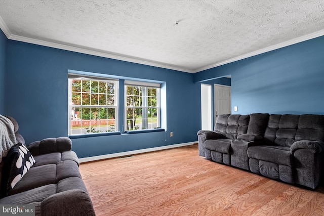 10462 Brackets Ford Cir, Manassas, VA 20110 - living room featuring wood finished floors, ornamental molding, a textured ceiling, and baseboards