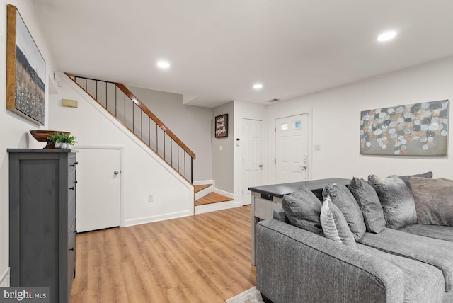 10627 Summer Oak Ct, Burke, VA 22015 - living area with light wood finished floors, stairway, and recessed lighting
