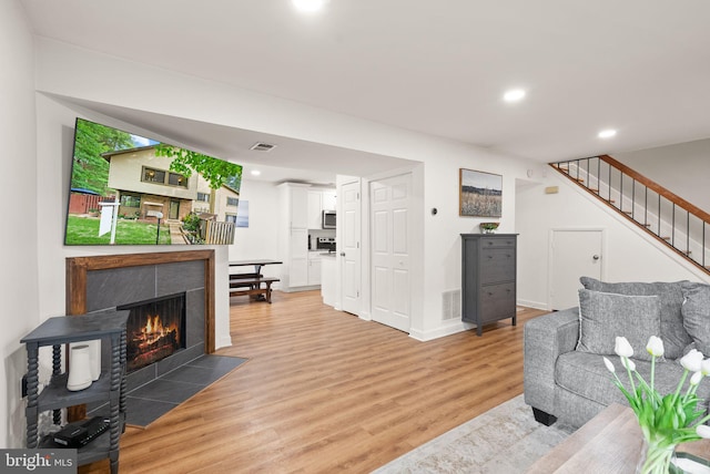 10627 Summer Oak Ct, Burke, VA 22015 - living area featuring light wood-type flooring, stairway, a fireplace, and recessed lighting