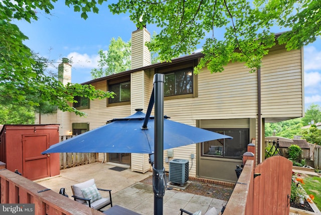 10627 Summer Oak Ct, Burke, VA 22015 - back of property with a patio, a storage unit, and a chimney