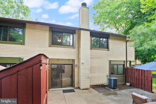 10627 Summer Oak Ct, Burke, VA 22015 - rear view of house featuring a chimney and a patio