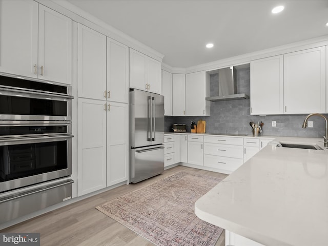 8101 Connecticut Ave Unit S 608, Chevy Chase, MD 20815 - kitchen featuring stainless steel appliances, wall chimney exhaust hood, a warming drawer, a sink, and white cabinets