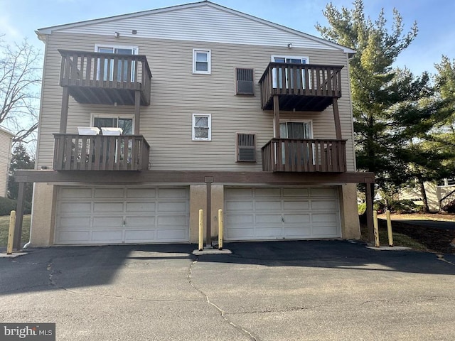 713A-2 Willow St # A-2, Lansdale, PA 19446 - back of house featuring a balcony, asphalt driveway, and a garage