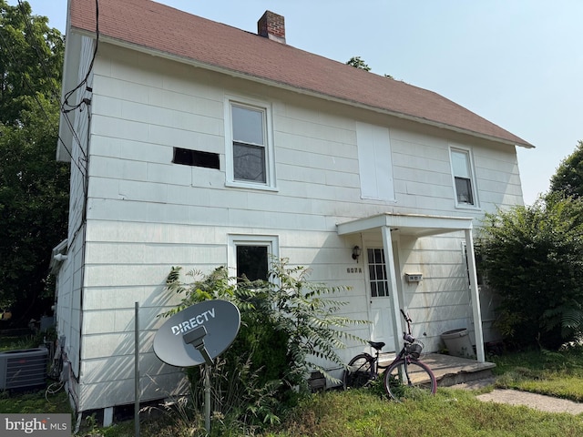 607 E Chestnut St, Delmar, MD 21875 - back of property with a chimney, a shingled roof, and cooling unit