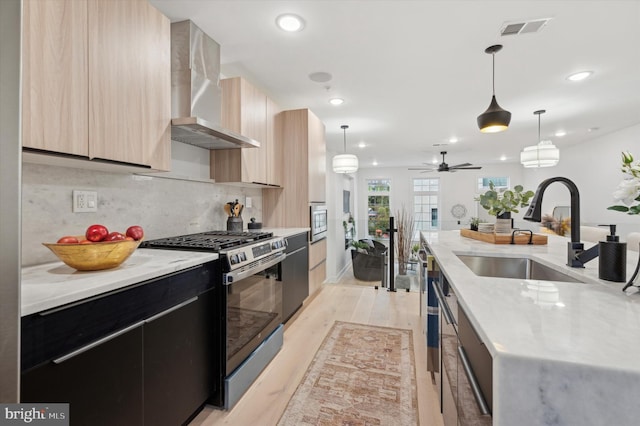 122 E Sharpnack St, Philadelphia, PA 19119 - kitchen featuring stainless steel gas range oven, wall chimney exhaust hood, light brown cabinetry, modern cabinets, and dark cabinets