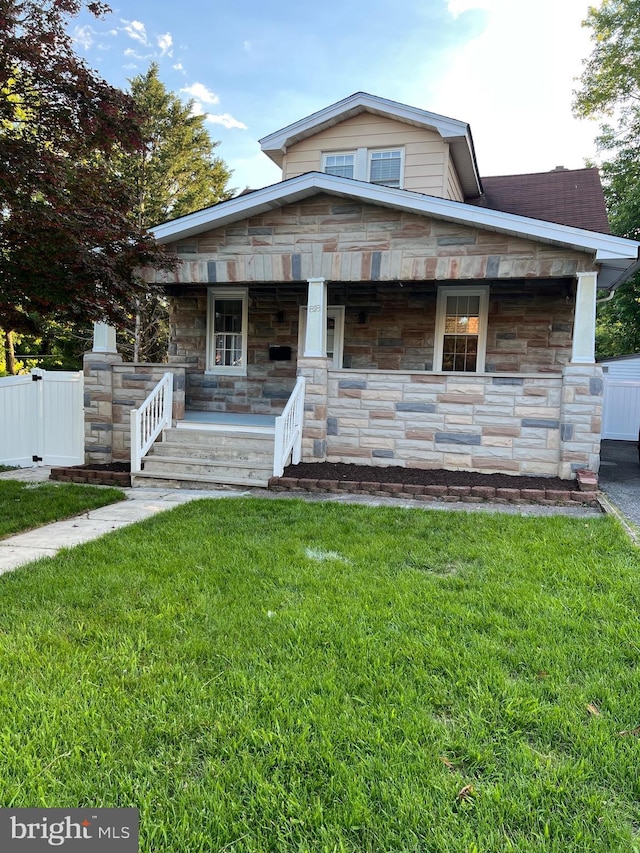 818 Warwick Rd, Baltimore, MD 21229 - view of front of home featuring a porch and stone siding