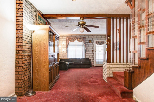 6051/2 N 16th St, Allentown, PA 18102 - carpeted living area featuring a ceiling fan, brick wall, stairway, and a textured ceiling