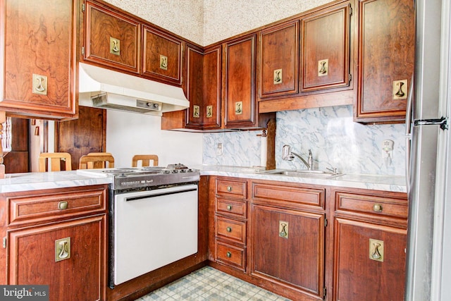 6051/2 N 16th St, Allentown, PA 18102 - kitchen with under cabinet range hood, range, a sink, light countertops, and freestanding refrigerator