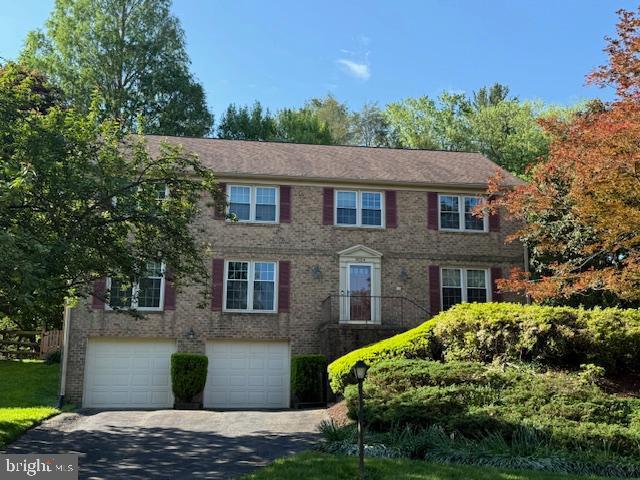 9024 Willow Valley Dr, Potomac, MD 20854 - colonial inspired home with asphalt driveway, a garage, and brick siding