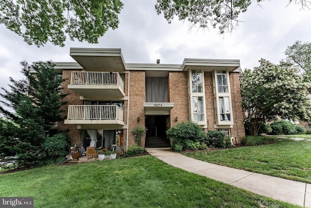 2624 Wagon Dr Unit 307, Alexandria, VA 22303 - view of front of home with brick siding, a balcony, and a front yard