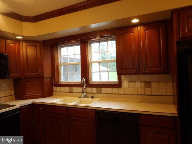 612 S Thomas St, Bedford, PA 15522 - kitchen featuring black appliances, a sink, light countertops, tasteful backsplash, and crown molding
